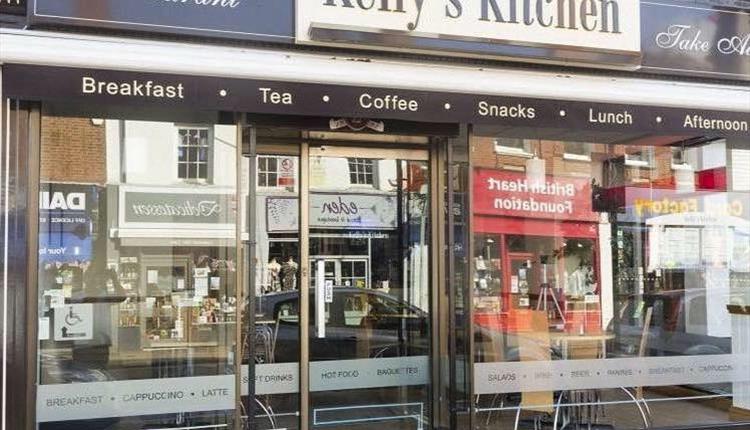 Kelly's Kitchen exterior with Christchurch high street visible in the shop window reflections.