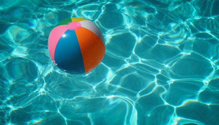 Inflatable ball floating in clear water.