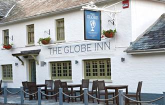 globe inn pub exterior painted white.